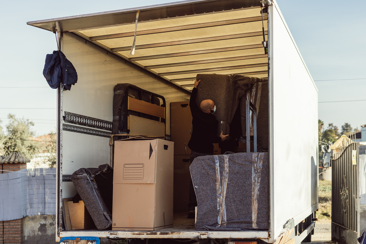 man working inside a white moving truck